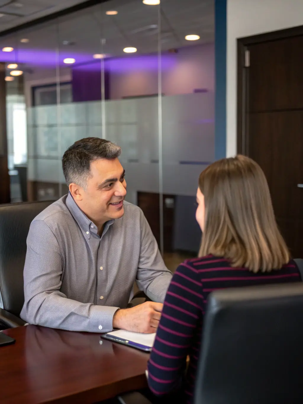 A person receiving personalized feedback and guidance from a career coach in a bright, modern office, representing personalized coaching sessions.